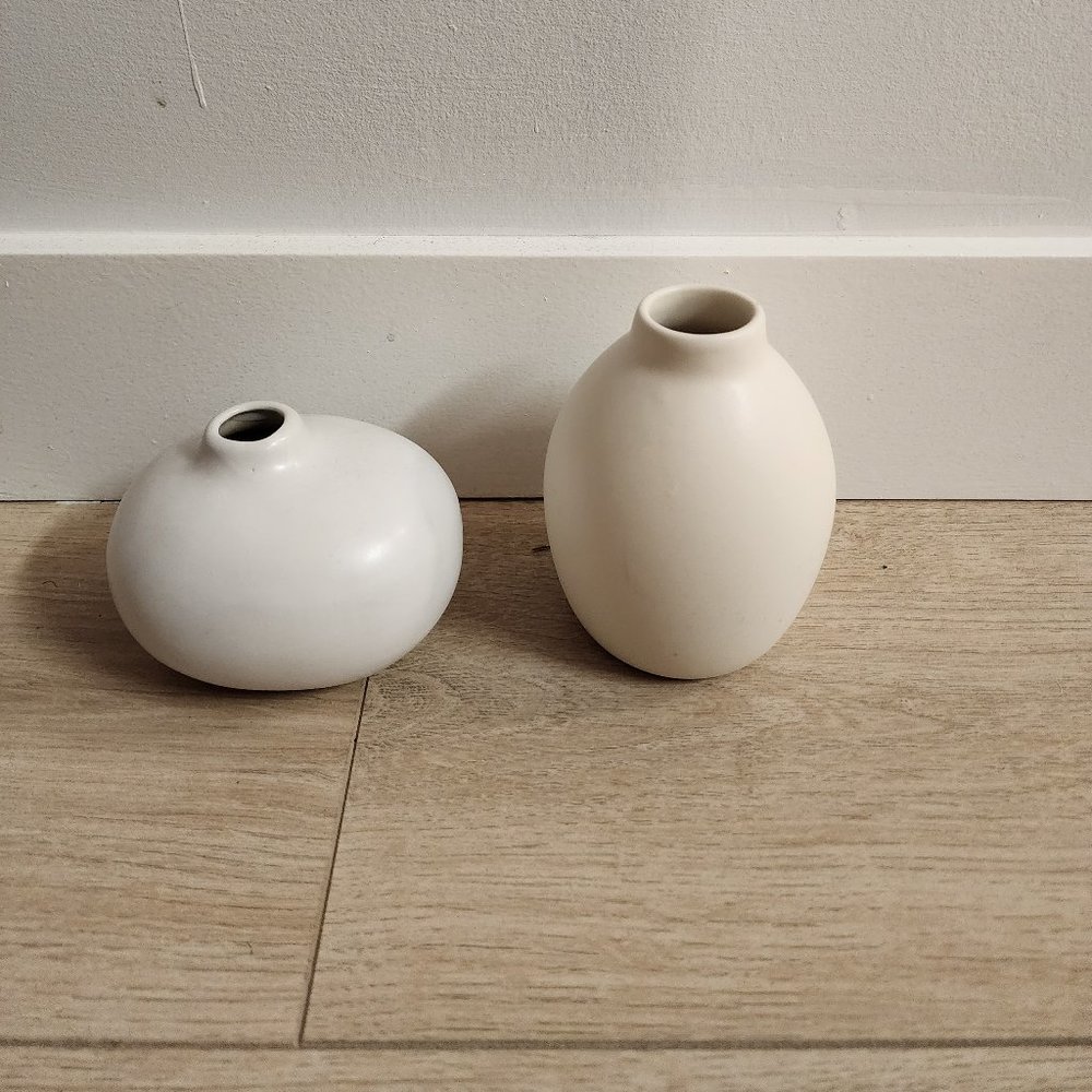 A pair of white ceramic bud vases